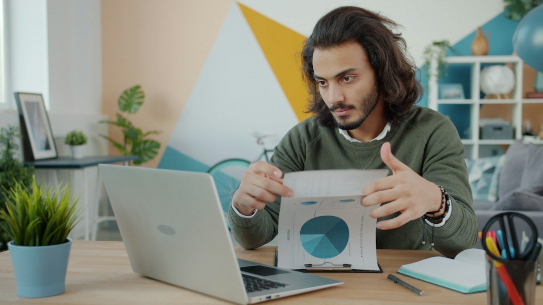 Small business owner reviewing Google Ads search term performance on a laptop