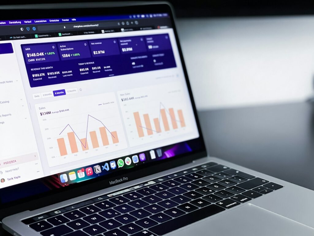 Laptop displaying performance charts on a desk, illustrating campaign analytics