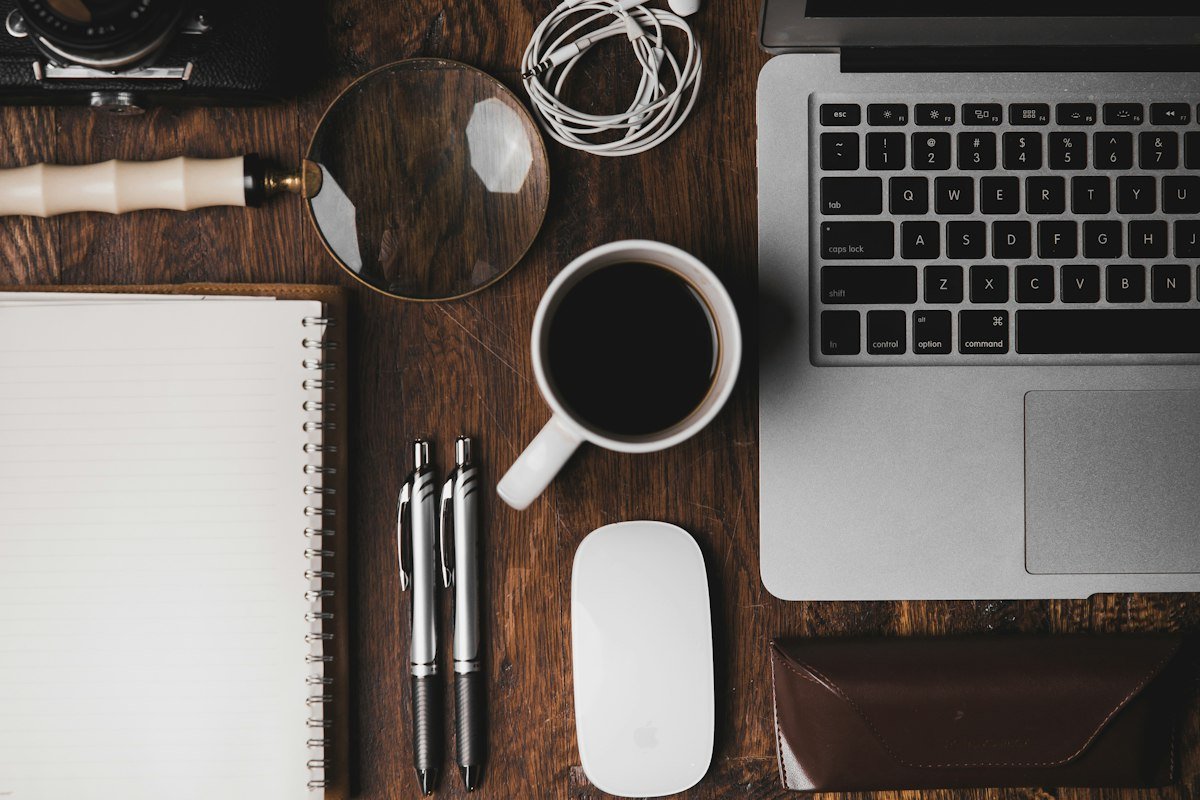 Desk with notebook and computer for planning and reviewing a landing page
