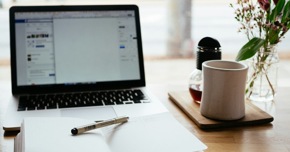 Laptop and notebook on a desk
